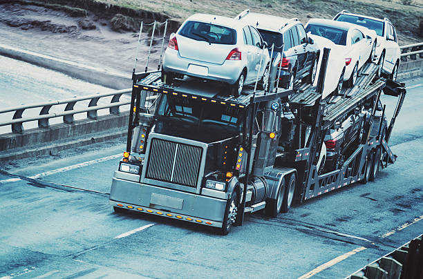 A car transporter straddles the center line of a provincial highway.